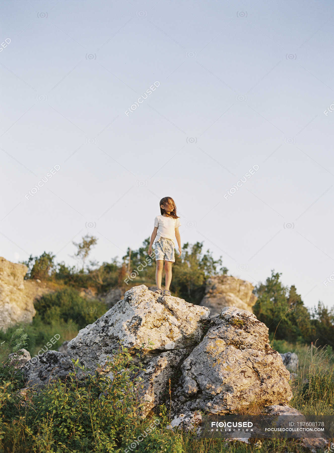 Girl Standing Over Rock Wallpapers