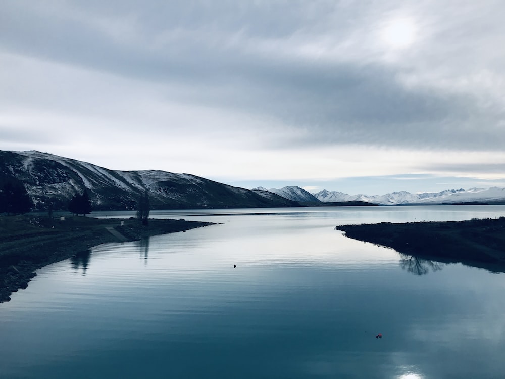 Cloudy Mountains In Lake Tekapo New Zealand Wallpapers